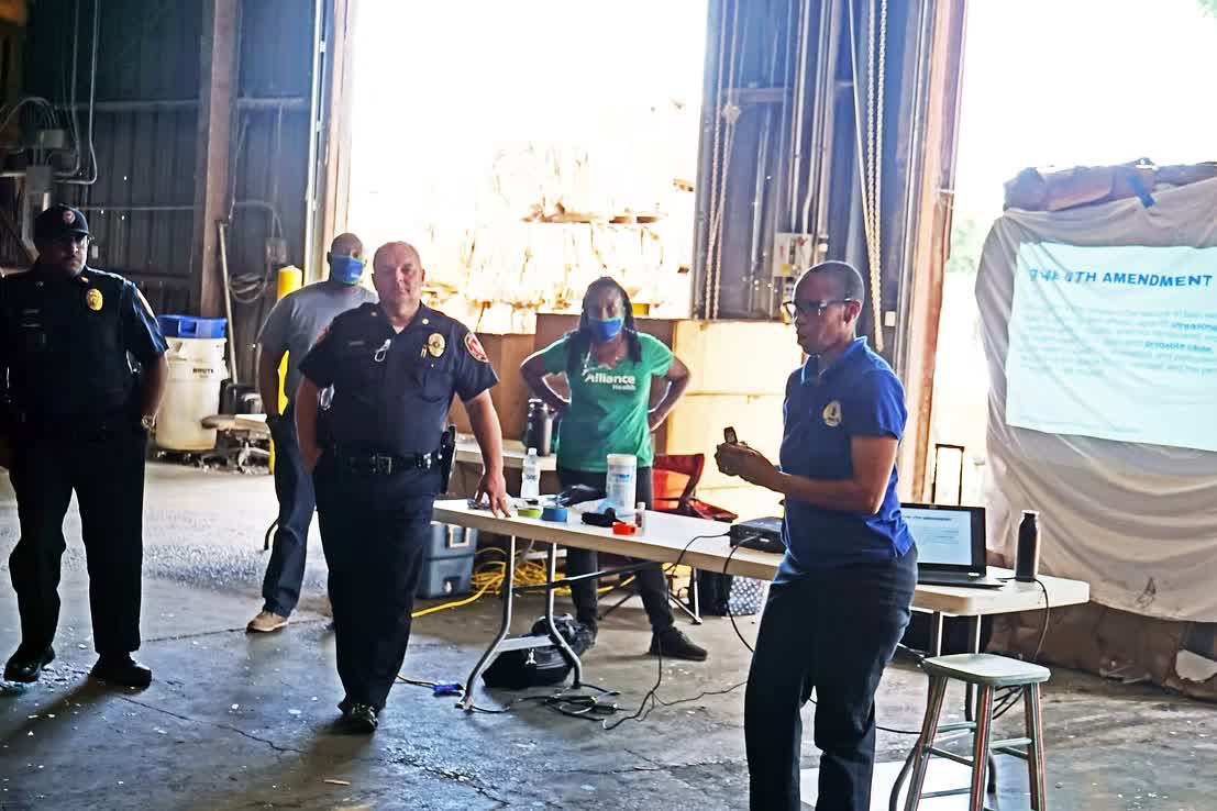 Law enforcement training with uniformed officers and the 4th Amendment banner
